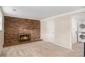 Living room featuring a brick fireplace and easy access to in-unit washer and dryer at 1962 S Ivory Way, Aurora, CO 80013