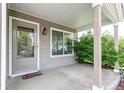 Welcoming front porch with a covered entry, decorative welcome mat, and adjacent window offering natural light at 5400 Perth St, Denver, CO 80249