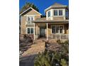 Two-story house featuring a wrap-around porch and bay window at 6297 W Prentice Ave, Littleton, CO 80123