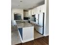 Modern kitchen with white cabinets, granite countertops, and stainless steel appliances at 6297 W Prentice Ave, Littleton, CO 80123