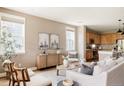 Sunlit living room featuring neutral décor, hardwood floors, and an open layout at 3415 Florence Way, Denver, CO 80238