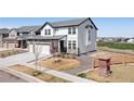 Beautiful two-story home featuring a stone and siding exterior, landscaping, and an attached garage at 11033 Olathe St, Commerce City, CO 80022