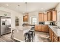 Modern kitchen with granite countertops, stainless steel appliances, and a functional island at 90 Pipit Lake Way, Erie, CO 80516