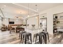 Open-concept kitchen with a large island and seating, seamlessly connected to the living area at 90 Pipit Lake Way, Erie, CO 80516