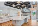 Modern kitchen boasts a center island with stone countertops, custom cabinetry, and professional-grade appliances at 135 Poorman Rd Rd, Boulder, CO 80302