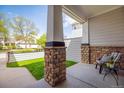 Inviting front porch features stylish columns and cozy seating for relaxing at 14000 Winding River Ct # T3, Broomfield, CO 80023