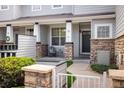 Inviting front porch with stone pillars and a cozy seating area perfect for relaxing outdoors at 14000 Winding River Ct # T3, Broomfield, CO 80023