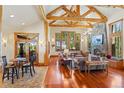Spacious living room features beautiful wood floors, exposed beams, stone fireplace, and large windows with scenic views at 378 Juniata Cir, Breckenridge, CO 80424