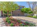 Beautiful two-story home featuring a spacious driveway and lush landscaping at 2364 S Harlan St, Lakewood, CO 80227