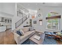 Bright living room with modern staircase, high ceilings, and a large window at 2364 S Harlan St, Lakewood, CO 80227