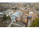 A home's aerial view, showcasing it's backyard, fence, driveway, and surrounding homes in the area at 1047 Meade St, Denver, CO 80204
