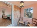 The entryway shows a stone wall, chairs, table, light fixture, and a view of the living room with hardwood floors at 1047 Meade St, Denver, CO 80204
