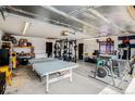 Spacious garage featuring workout equipment and ample space for parking and storage at 1293 S Perry St, Denver, CO 80219