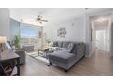 Open-concept living room featuring a large window, a ceiling fan, and modern decor at 17297 Wilde Ave # 205, Parker, CO 80134