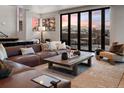 Cozy living room featuring a leather sofa, mountain views, and natural light at 310 N Fuller Placer Rd, Breckenridge, CO 80424