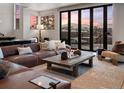 Cozy living room featuring a leather sofa, mountain views, and natural light at 310 N Fuller Placer Rd, Breckenridge, CO 80424