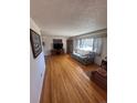 This living room has hardwood floors, a large window and an adjacent sitting area or sunroom at 1419 S Terry St, Longmont, CO 80501