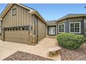 Exterior of a home with a lush green lawn and charming stone facade details at 21107 Hawthorne Ln, Parker, CO 80138