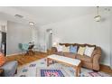 Living room with a patterned rug, sofa, and a dining table at 3285 S Delaware St, Englewood, CO 80110