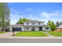 Inviting home with a fresh lawn and a dark-colored garage door, offering a classic yet modern curb appeal at 5853 S Havana Ct, Englewood, CO 80111