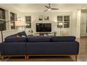 Comfortable living room with dark wood flooring, ceiling fan, and lots of natural light at 13788 Umatilla Ln, Broomfield, CO 80023