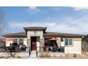 Charming single-story home with inviting front porch and modern architectural details provides great curb appeal at 10845 Bear Cub Dr, Broomfield, CO 80021