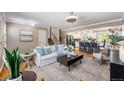 Comfortable living area showcasing the staircase, kitchen, and hardwood floors at 8712 W 64Th Way, Arvada, CO 80004
