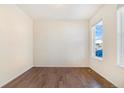 Empty spare bedroom with wood floors and a window at 7242 E 133Rd Cir, Thornton, CO 80602