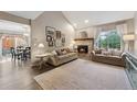 Inviting living room with a fireplace, neutral decor, and a view to the adjacent dining area at 938 W Peakview Cir, Littleton, CO 80120