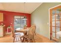 Bright dining area featuring a round wooden table, chairs, and sliding glass door to the backyard at 19326 E Greenwood Pl, Aurora, CO 80013