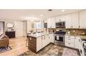 Well-lit kitchen boasts a functional island, stainless steel appliances, and ample cabinet space at 6900 S Clermont St, Centennial, CO 80122