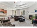 Inviting living room open to dining area featuring a fireplace and abundant natural light at 2558 Northview Pl, Castle Rock, CO 80104