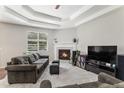 Comfortable living room with fireplace, ceiling fan, and large window overlooking the backyard at 2558 Northview Pl, Castle Rock, CO 80104