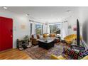 Bright living room with large windows, a comfortable leather sectional, and stylish decor accents at 111 S Perry St, Denver, CO 80219