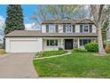 Charming two-story home with a well-manicured lawn and classic architectural details at 6712 S Leyden Ct, Centennial, CO 80112