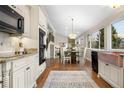 Open-concept kitchen and dining area featuring granite countertops, modern appliances, and stylish lighting at 6508 E Euclid Pl, Centennial, CO 80111