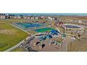 Aerial view of a community park with tennis and basketball courts and playground at 14106 Red Cosmos St, Parker, CO 80134