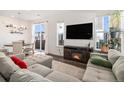 Comfortable living room featuring a fireplace, large TV, and a dining area with access to a patio at 14106 Red Cosmos St, Parker, CO 80134