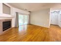 Bright living room featuring hardwood floors, a fireplace, and access to the outside at 8338 S Independence Cir # 104, Littleton, CO 80128