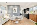 Dining area with an open floor plan connected to the modern kitchen at 3435 Lawrence St, Denver, CO 80205