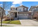 Charming two-story home with a well-manicured lawn and attached two car garage at 24784 E Tennessee Pl, Aurora, CO 80018