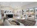 Open-concept living room features a seamless flow into the modern kitchen and dining area at 8015 Parnassus Pl, Castle Rock, CO 80108