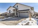 Beautiful house showcasing stone accents, a two-car garage, and mature landscaping at 8926 S Rome Ct, Aurora, CO 80016