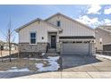 Charming two-story home featuring stone accents, a two-car garage, and a well-maintained lawn at 8926 S Rome Ct, Aurora, CO 80016