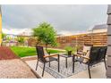 Relaxing backyard features a patio with outdoor seating and lush green lawn at 6892 Juniper Ct, Arvada, CO 80007