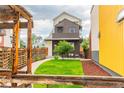 Beautifully landscaped front yard with green lawn and modern fence at 6892 Juniper Ct, Arvada, CO 80007