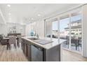 Modern kitchen with island, stainless steel appliances, and sliding glass door to patio at 24501 E 41St Ave, Aurora, CO 80019