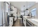 Bright and spacious kitchen with white cabinets, stainless steel appliances, and a breakfast bar at 4045 Shoshone St, Denver, CO 80211