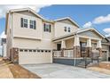 Charming two-story home featuring neutral siding, stone accents, covered porch, and a two car garage at 20724 E 57Th Ave, Aurora, CO 80019