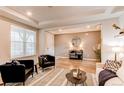 Inviting living room featuring wood floors, modern decor, and a view of the home's entryway at 8107 Arapahoe Peak St, Littleton, CO 80125